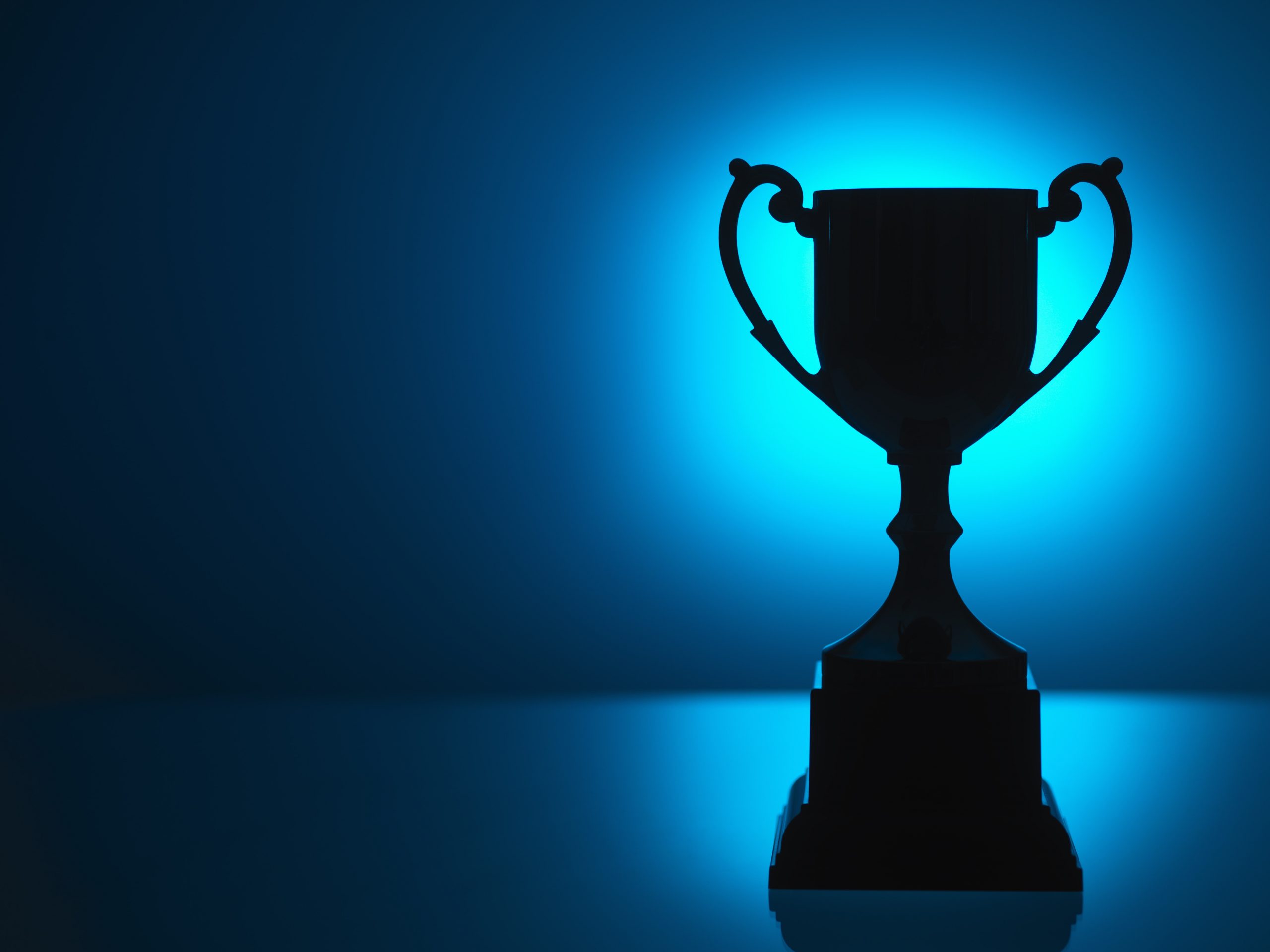 Silhouetted trophy with blue background